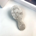 Detailed macro view of pearly white acetate comb with marble texture and wavy edges - White Comb 13.6cm