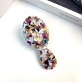 Detailed macro view of acetate hair comb featuring vibrant purple and orange marble texture - Floral Purple Comb 13.6cm