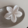 Close-up of white acetate flower hair claw clip with elegant marble texture on a ceramic plate - Ink Texture-White Flower (Small)