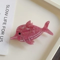 Detail view of pink marble textured acetate fish hair claw clip on minimalist beige tray - 8.3cm / Pink Dolphin