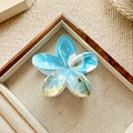Detail shot of a blue floral hair claw clip with dandelion print in a wooden tray - Dandelion Print
