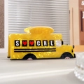 Dettaglio di un fermaglio per capelli a bus scolastico giallo in acetato con strass - Scuolabus Lettera
