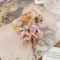 Macro detail of the acetate flower hair claw clip with colorful marble texture and pattern - Colorful