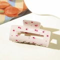 Detailed view of rectangular hair claw clip with pink floral pattern and glossy finish - Pink Marble Pattern
