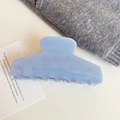 Detail view of light blue acetate shark hair claw clip with pearl accents on a white surface - 10.5cm / Blue
