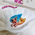 Macro shot of an acrylic mermaid hair claw with pearlescent finish and floral details - Blue Orange Mermaid Tail Red Flower Claw
