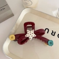 Close-up of red bow hair claw with contrast polka dot star and colorful button accents - 12cm / Burgundy