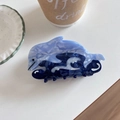Detail view of acetate dolphin hair claw clip with blue marble texture and wave base - Blue Dolphin Shape