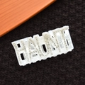 Macro shot of white marble texture hair claw with HAUNT rhinestone lettering detail - Rhinestone HAUNT Style / 10cm