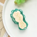 Close-up of emerald green marble acetate hair claw clip with cream accents on a white plate - Emerald Green Cabbage (8.5cm)