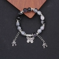 Ethno-Schmetterling-Armband mit violetten Steinperlen und silbernen Metall-Quasten - Schwarzer Farbverlauf Lampwork Armband