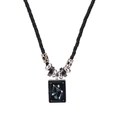 Macro view of woven black leather rope necklace with a Libra constellation pendant - Libra