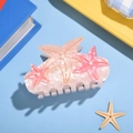 Starfish hair claw clip with pearlescent resin and pink starfish accents on blue background - Light Triple Stars 8.5cm
