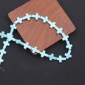 Bright blue synthetic turquoise cross beads for jewelry making on wooden tray - Standard Bead Strand / Blue Cross (MS-0031)