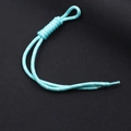 Detail of cyan woven nylon zipper pull with white reflective dots and heat-shrink end cap - Lake Blue + White Dots (KC-0097)