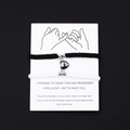Detail of magnetic heart charms on black and white woven couple bracelets with pinky swear card - Black White Rope Steel Color Magnetic Heart Fully Woven
