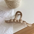 Detail of large beige ribbon-shaped shark hair clip with gold lettering on a textured card - Large (13cm) / Khaki