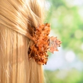 Macro shot of maple leaf hair claw with tortoise pattern and rhinestones in golden hair - 8cm / Brown Tortoise Pattern