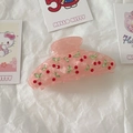 Detailed view of pink acetate hair claw clip featuring sparkling rhinestone cherry design - Pink