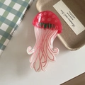 Detail shot of a creative jellyfish hair claw clip with floral relief on a pink acrylic surface - Star Style Pink 9.5cm