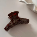 Detail view of tortoiseshell acetate claw clip showing polished amber pattern and teeth - Brown Coffee Marble (8cm)