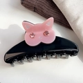 Close-up of black glossy hair claw featuring a pink cat head with sparkling rhinestones - Pink 9cm