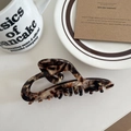 Detailed view of hollow heart hair claw clip with vintage tortoiseshell texture on table - Coffee 11.5cm