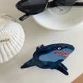 Detailed close-up of blue marble acetate shark hair claw clip with nautical props - Shark