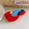 Detailed close-up of a colorful parrot hair claw clip made of vibrant red acetate - Parrot (9.5cm)