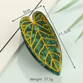 Leaf-shaped acetate hair claw clip in dark green with yellow veins, 11.3cm length - Olive Green