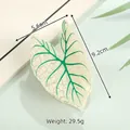 Detail view of leaf-shaped acetate hair claw clip with size dimensions 9.2cm and 5.6cm - Off-white