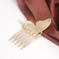 Close-up of golden butterfly hair comb with five-tooth structure and brushed metal texture - Gold