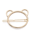 Detail of a minimalist golden bear-shaped metal hair clip with a sleek polished finish - Gold Bear Outline Style
