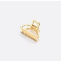 Macro shot of polished gold metal hair claw clip with cutout semicircular structure - Small Gold