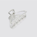 Close-up of a silver alloy hollow hair claw clip with a polished metallic finish - Silver