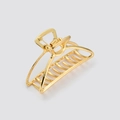 Detailed macro view of the shiny gold metal alloy claw clip showing strong inner spring - Gold