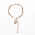 Detail of double-layer beaded bracelet with golden flower charm and crystal inlay - Gray Beads with Flower Charm