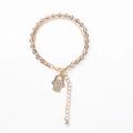 Macro detail of Hamsa Hand charm with crystals and beaded multi-layer bracelet - Gray Beads with Hamsa Hand