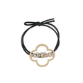 Detail of clover metal charm with white pearls on a black elastic hair tie - Four-Leaf Clover Style