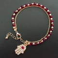 Hamsa Hand Armband mit roten Perlen, Goldbeschichtung und funkelnden Kristallsteinen - Rot