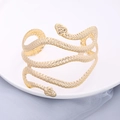Exaggerated golden double-headed snake cuff bracelet with textured scale finish - Gold