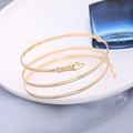 Chic golden spiral snake arm cuff featuring realistic scales and a bohemian punk style - Gold