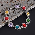 Close-up of colorful crystal necklace with pavé diamonds on a dark volcanic stone - Bracelet / Silver 02801