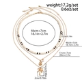 Drielaagse ketting set met kokoskralen, schelphanger en goudkleurige palmboom bedel - Goud