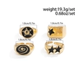 4-piece gold-tone star and spiral ring set with black enamel details and open design - Ring Set / Gold