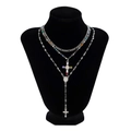Detailed macro of silver-plated Y-shaped layered necklace with colorful beads and cross - Silver