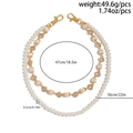 Dettaglio della catena per pantaloni in perle a strati con croci e chiusure a moschettone - Oro (01756)