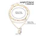 Parure collier triple rang doré avec pendentif croix, perles et soleil - Or