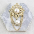 Vintage Baroque gold brooch with hollow floral design, white pearls, and long tassels - Gold