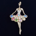 Detailed macro of a ballerina brooch featuring colorful rhinestones on a gold base - Colorful